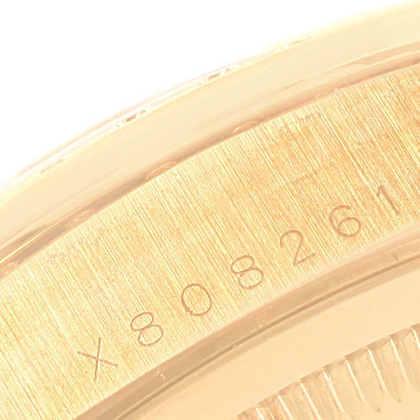 This close-up image shows the serial number engraved on the gold case back of a Rolex President 18248 Men
s Yellow Gold White Dial 18248 Men
s Yellow Gold White Dial model watch.