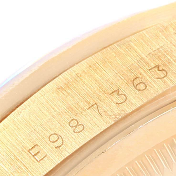 This close-up image shows the engraved serial number on the side of a Rolex President 18248 Men's Yellow Gold Champagne Dial 18248 Men's Yellow Gold Champagne Dial model watch.