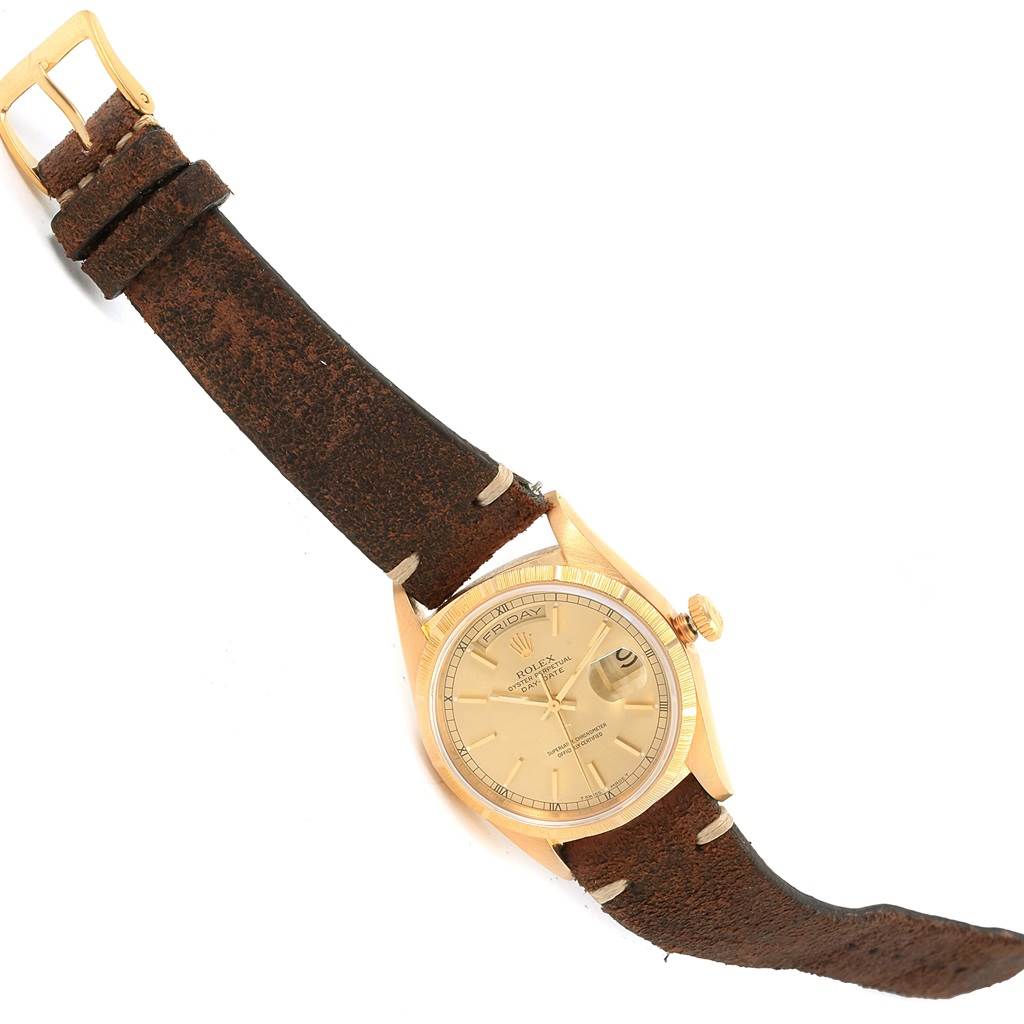 This image displays a Rolex President 18248 Men's Yellow Gold Champagne Dial 18248 Men's Yellow Gold Champagne Dial model watch at a slightly tilted angle, showcasing the face, crown, and leather strap.