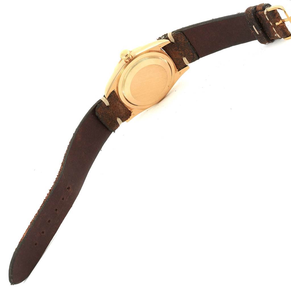 This image shows the back and side view of a Rolex President 18248 Men's Yellow Gold Champagne Dial 18248 Men's Yellow Gold Champagne Dial model watch with a leather strap and gold casing.