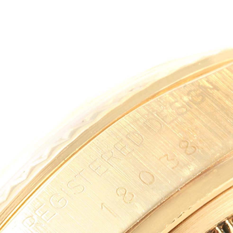 The image shows a close-up of the case side of the Rolex President 18038 Men
s Yellow Gold Beige Dial 18038 Men
s Yellow Gold Beige Dial model watch, highlighting engraved text.