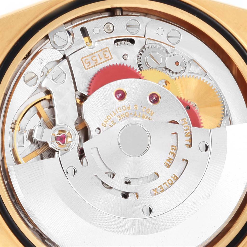 This image shows a close-up, top-down view of the inner mechanical movement of a Rolex President 18238 Men's Yellow Gold Black Dial 18238 Men's Yellow Gold Black Dial model watch, revealing various gears and components.
