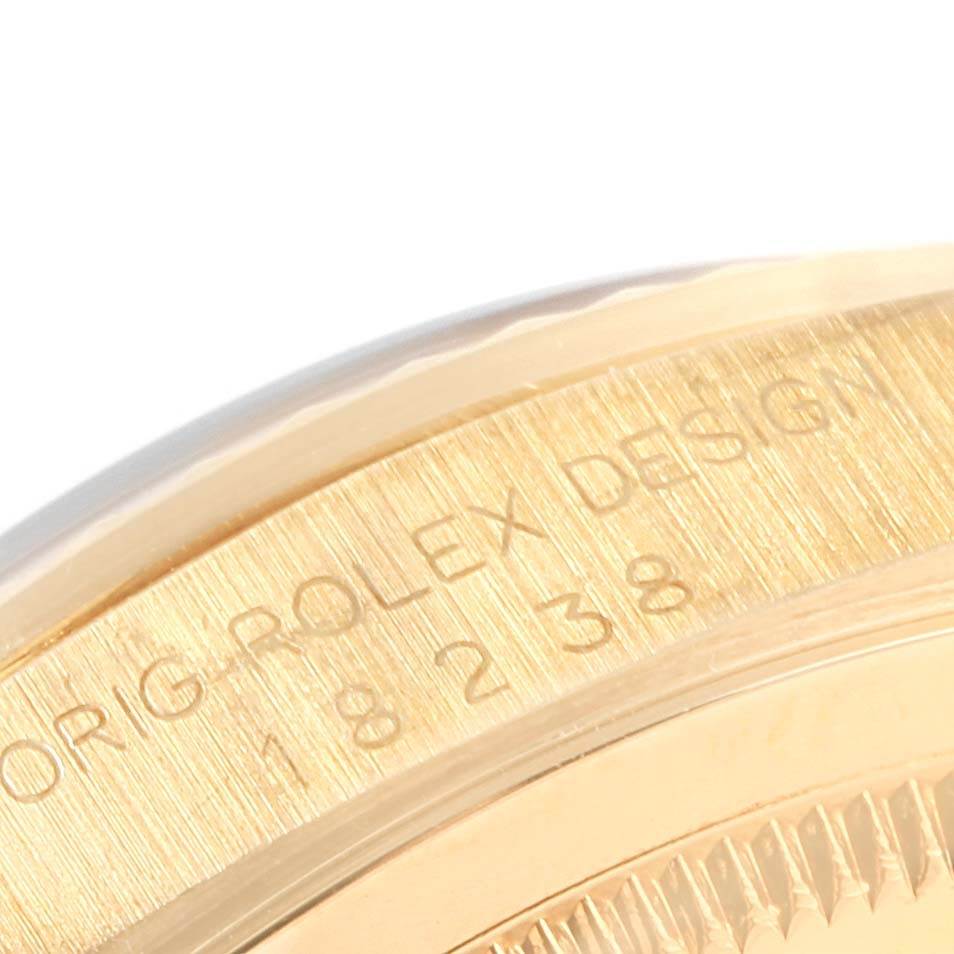 This close-up image shows the edge of the gold case and part of the bezel of a Rolex President 18238 Men's Yellow Gold Black Dial 18238 Men's Yellow Gold Black Dial model watch.