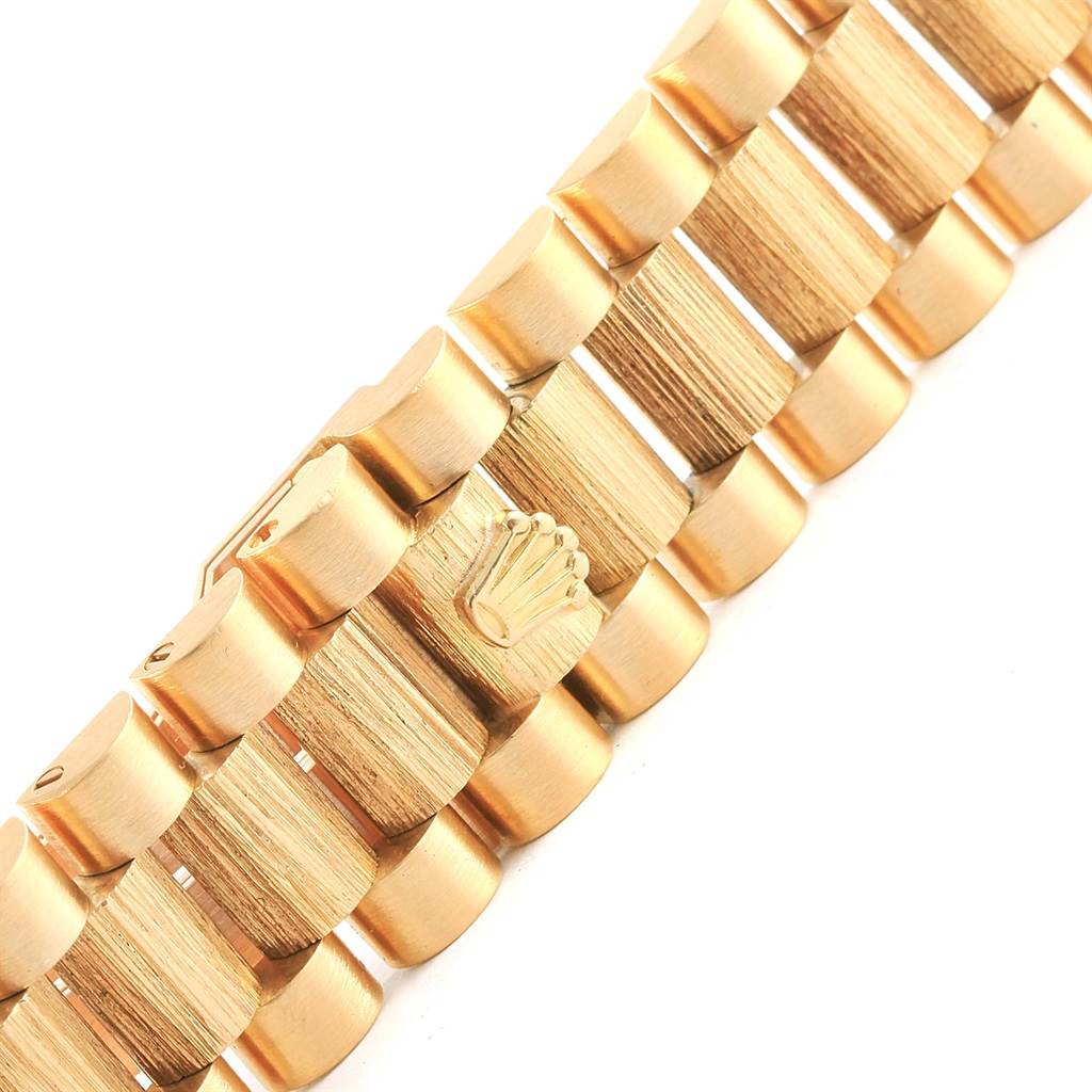 This image shows a close-up angle of the gold bracelet of a Rolex President 18078 Men's Yellow Gold Champagne Dial 18078 Men's Yellow Gold Champagne Dial model watch, featuring the Rolex crown logo.