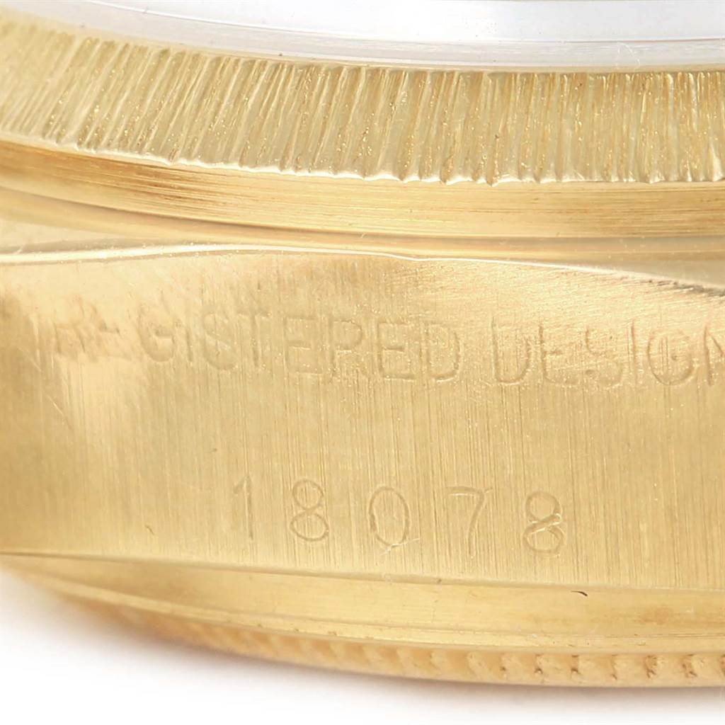 This image shows a close-up of the side of a Rolex President 18078 Men's Yellow Gold White Dial 18078 Men's Yellow Gold White Dial model watch, featuring its serial number 18078 and part of the fluted bezel.