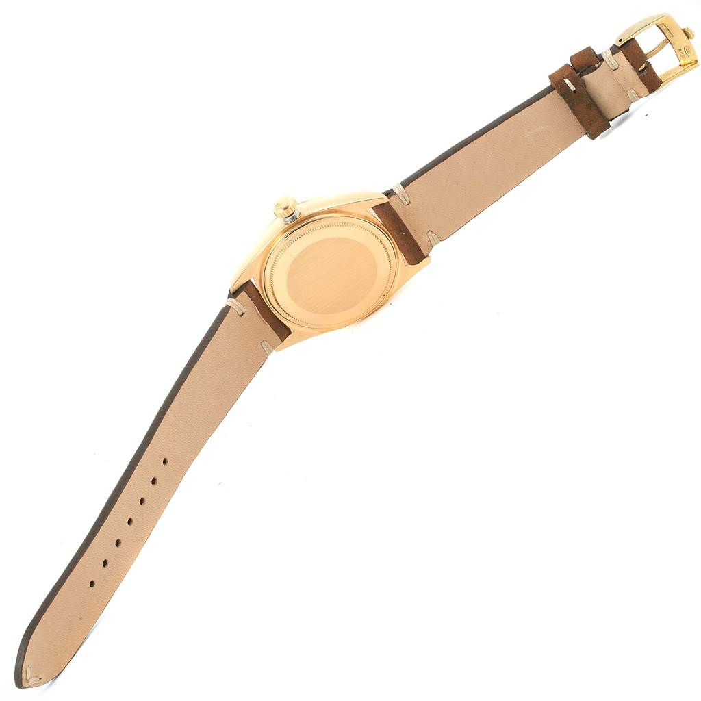 This image shows the back case and leather straps of a Rolex President 18078 Men's Yellow Gold White Dial 18078 Men's Yellow Gold White Dial model watch from a top-down angle.