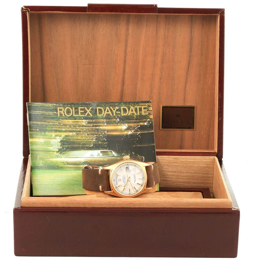 The Rolex President 18078 Men's Yellow Gold White Dial 18078 Men's Yellow Gold White Dial watch is shown in its open box with a Rolex Day-Date booklet beside it, viewed from the front.