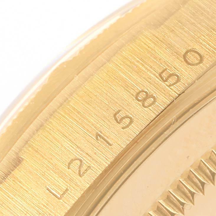 The image shows a close-up of the engraved bezel area on a Rolex President 18248 Men's Yellow Gold Champagne Dial 18248 Men's Yellow Gold Champagne Dial model watch.