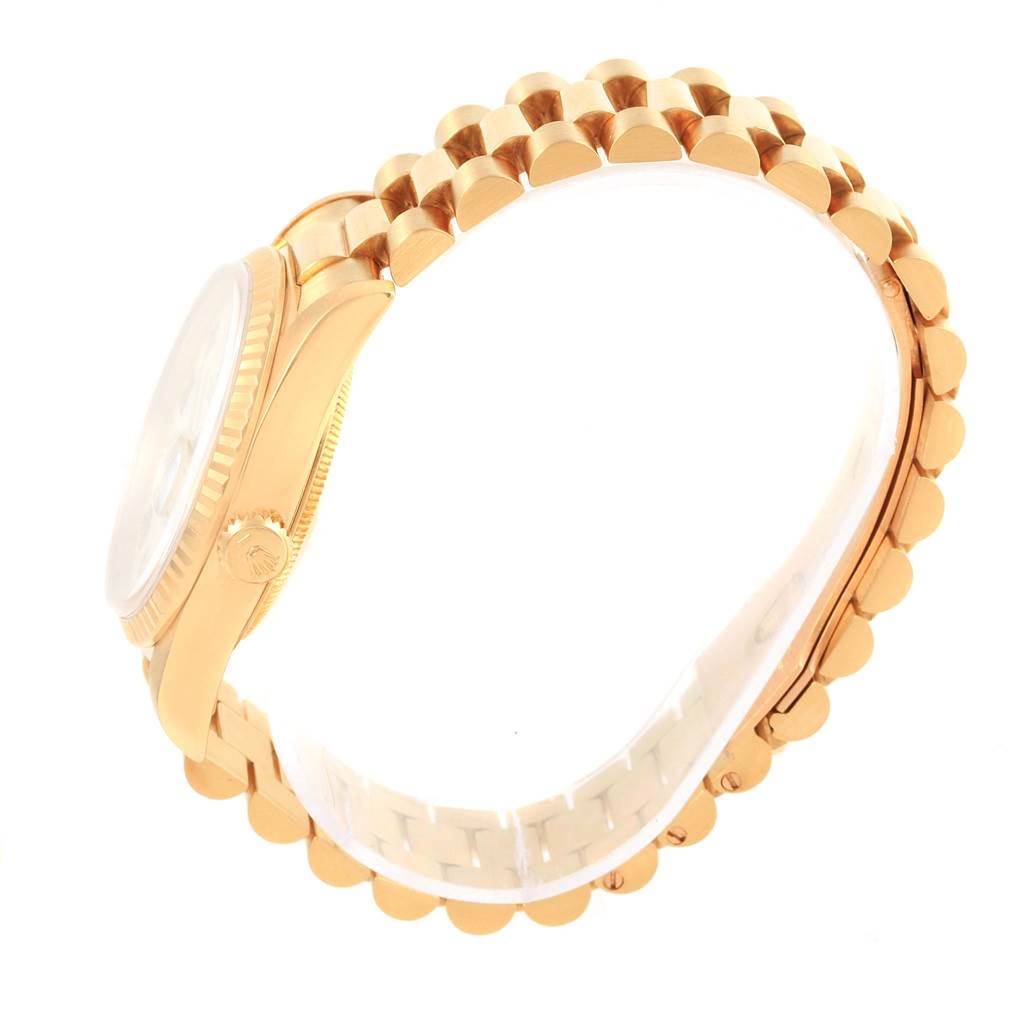 The image shows a side view of a Rolex President 18238 Men's Yellow Gold White Dial 18238 Men's Yellow Gold White Dial model watch, highlighting its band and partially visible case and crown.