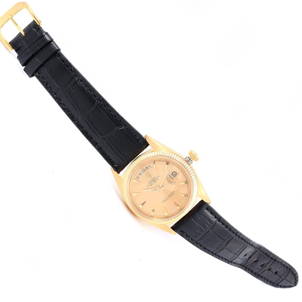 The watch is a Rolex President 1803 Men's Yellow Gold Champagne Dial 1803 Men's Yellow Gold Champagne Dial model shown at a slightly tilted angle, displaying the face, crown, and black leather strap.