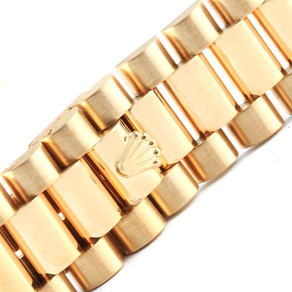 This close-up image shows the gold bracelet clasp of the Rolex President 18238 Men's Stainless Steel Champagne Dial 18238 Men's Stainless Steel Champagne Dial model watch.