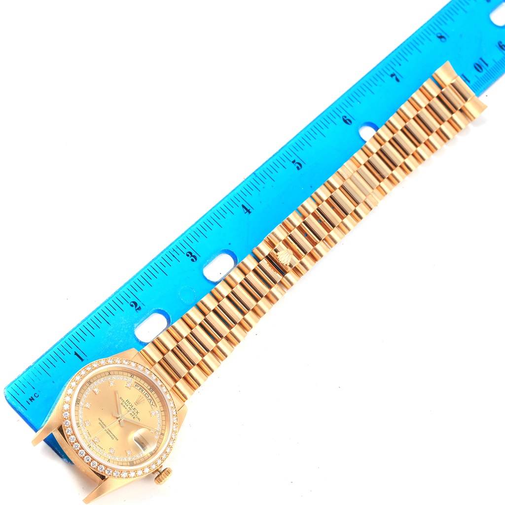 This image shows the dial, bezel, and full bracelet of a Rolex President 18238 Men's Yellow Gold Champagne Dial 18238 Men's Yellow Gold Champagne Dial watch next to a blue ruler.
