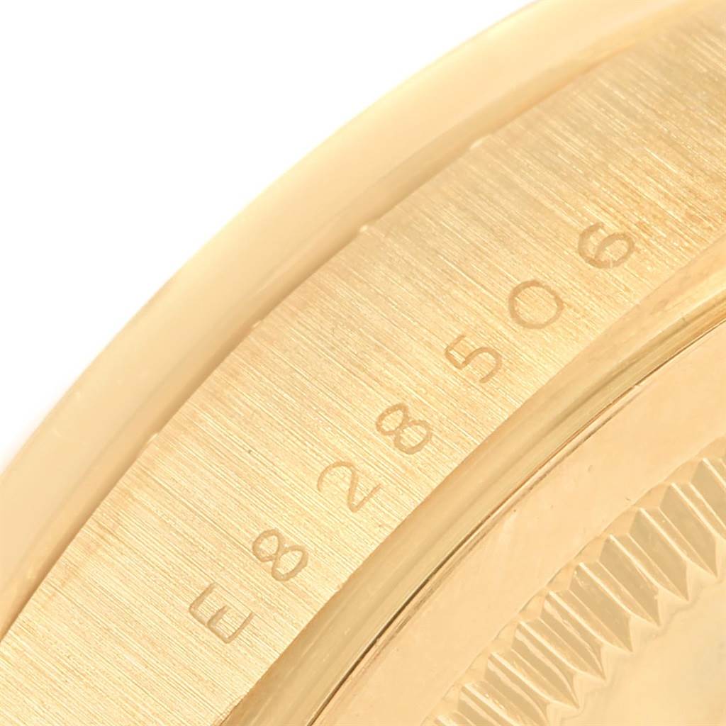 This image shows a close-up of the side of the President model by Rolex, including part of the bezel and serial number.