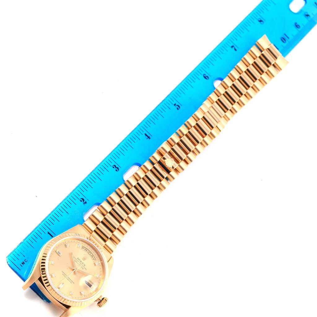 The image shows a top-down view of a Rolex President 18238 Men's Yellow Gold Champagne Dial 18238 Men's Yellow Gold Champagne Dial model watch, displaying its face, bracelet, and a blue measuring ruler beside it.