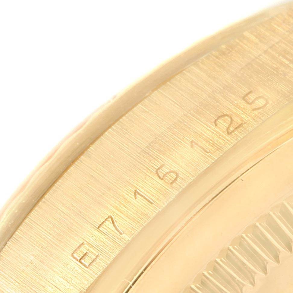 This close-up image shows the serial number and part of the bezel of a Rolex President 18238 Men's Yellow Gold Champagne Dial 18238 Men's Yellow Gold Champagne Dial model watch.