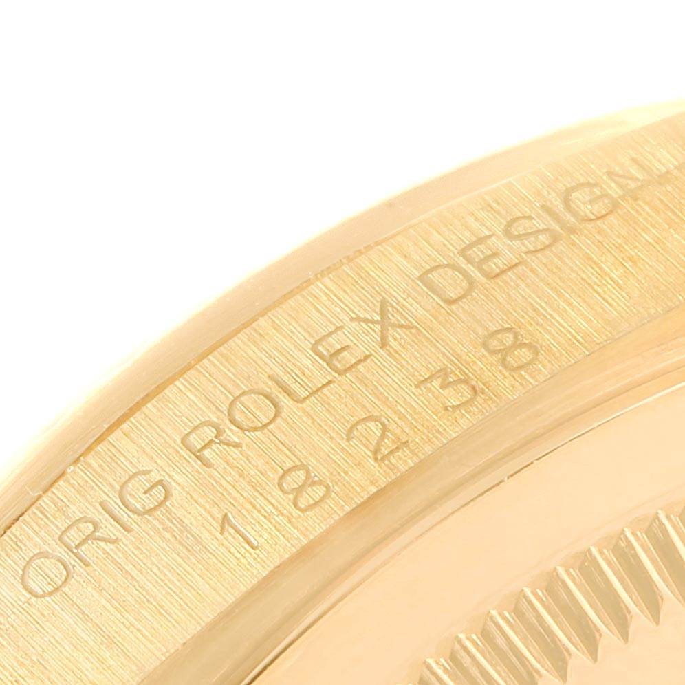 The image shows a close-up of the side of a Rolex President 18238 Men's Yellow Gold Champagne Dial 18238 Men's Yellow Gold Champagne Dial model watch, focusing on the engraved text and part of the bezel.