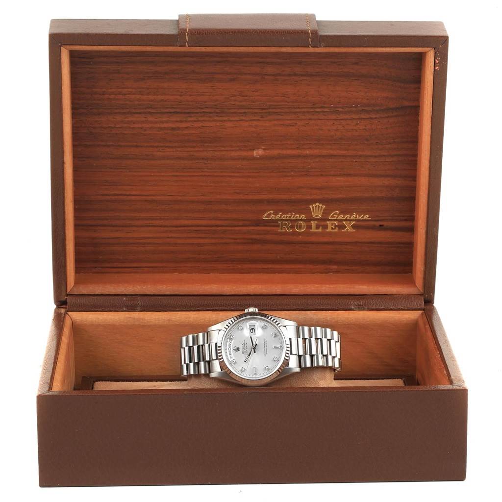 The Rolex President 18239 Men's White Gold Silver Dial 18239 Men's White Gold Silver Dial model watch is shown front-on in its open, brown and wooden display box.