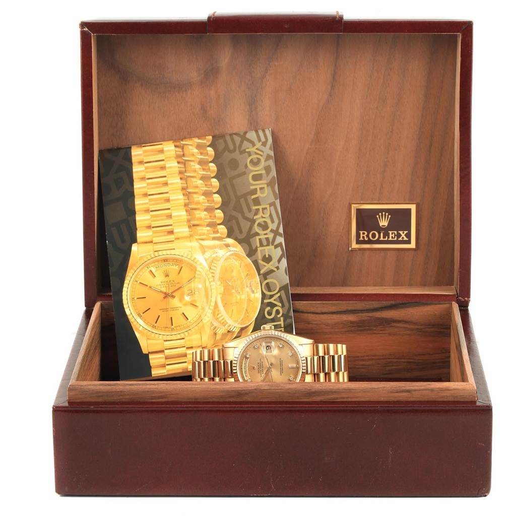 The image shows a Rolex President 18238 Men's Yellow Gold Champagne Dial 18238 Men's Yellow Gold Champagne Dial model watch and an information booklet inside an open wooden Rolex case.