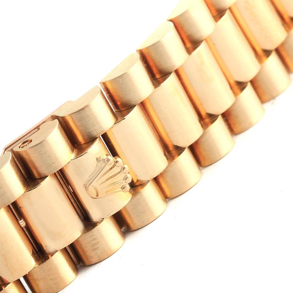 The image shows a close-up of the gold bracelet of a Rolex President 18238 Men's Yellow Gold Champagne Dial 18238 Men's Yellow Gold Champagne Dial model watch, featuring the Rolex crown logo.