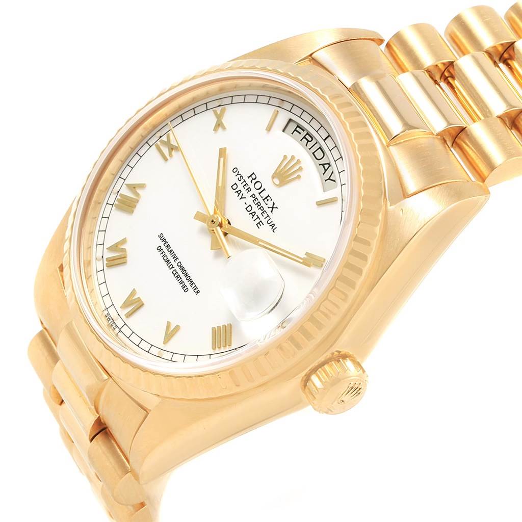 This image shows an angled view of a Rolex President 18038 Men's Yellow Gold White Dial 18038 Men's Yellow Gold White Dial model watch, highlighting its face, bezel, crown, and part of the bracelet.