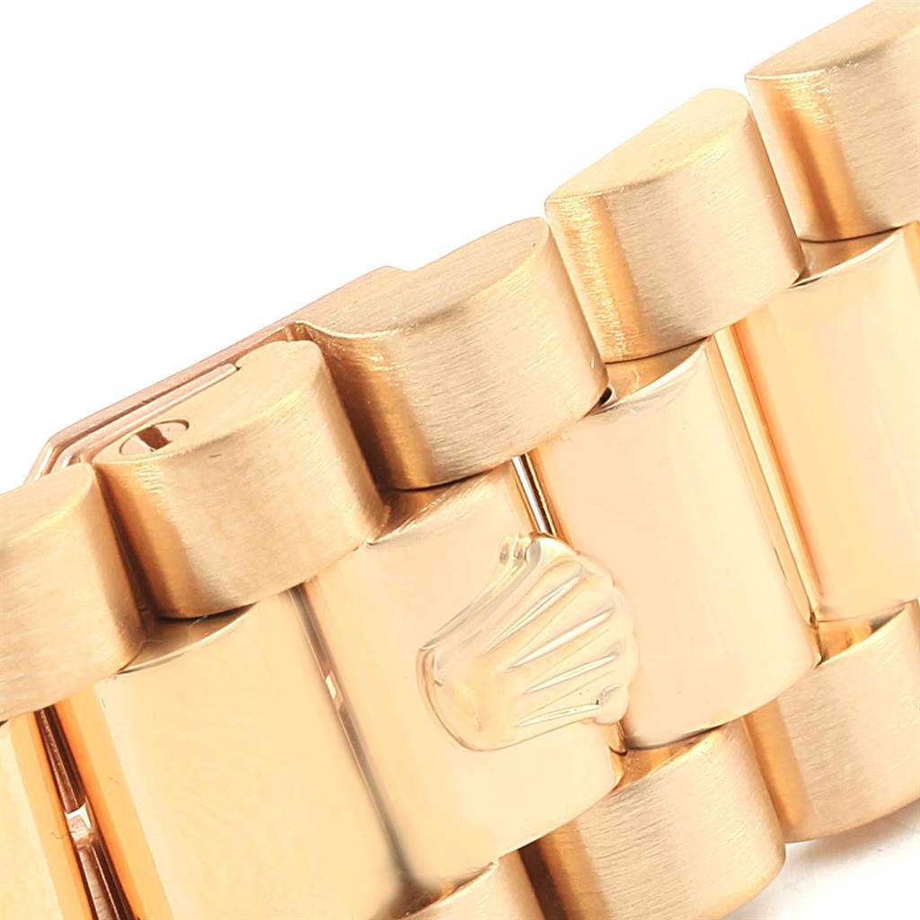 This image shows a close-up of the bracelet links of a Rolex President 18038 Men's Yellow Gold White Dial 18038 Men's Yellow Gold White Dial model watch, highlighting its gold finish and clasp crown logo.