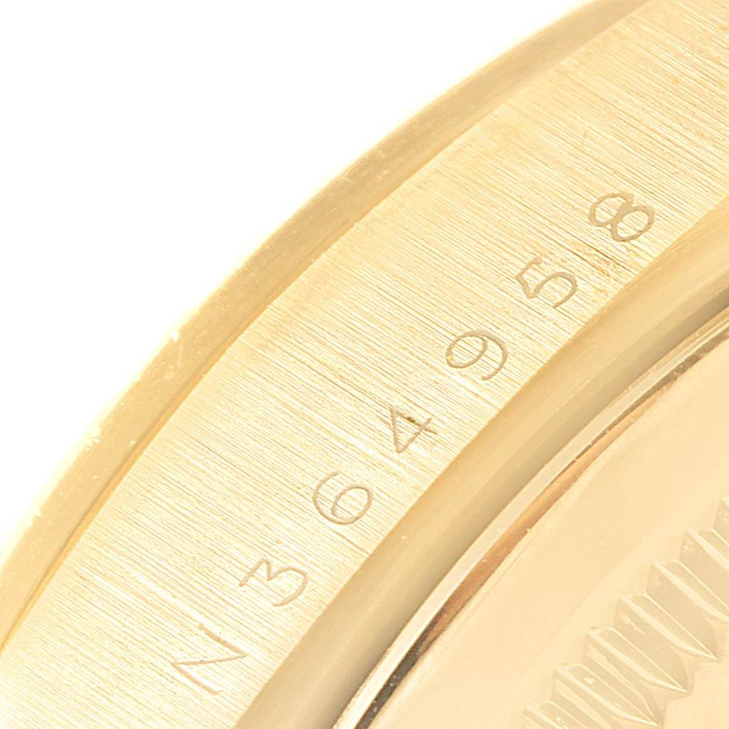 The image shows a close-up of the gold bezel and part of the dial from a Rolex President 18238 Men's Yellow Gold Champagne Dial 18238 Men's Yellow Gold Champagne Dial model watch.
