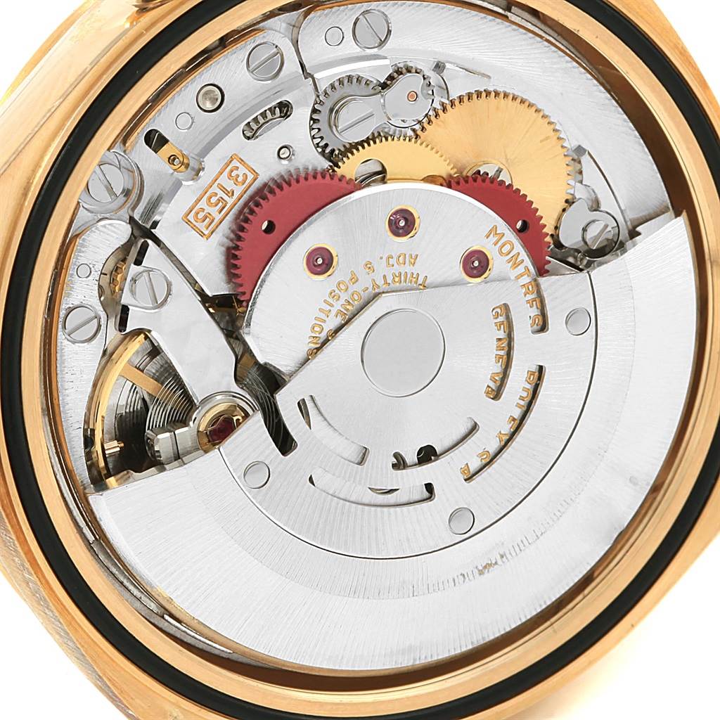 The image shows a close-up of the internal mechanism of a Rolex President 18238 Men's Yellow Gold White Dial 18238 Men's Yellow Gold White Dial model watch, highlighting its intricate gears and movement parts.