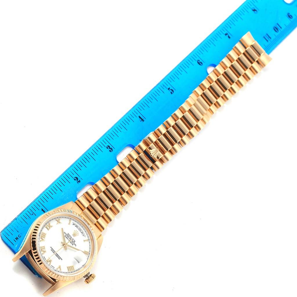 The image shows a Rolex President 18238 Men's Yellow Gold White Dial 18238 Men's Yellow Gold White Dial model watch, focusing on the face and bracelet alongside a ruler for measurement.