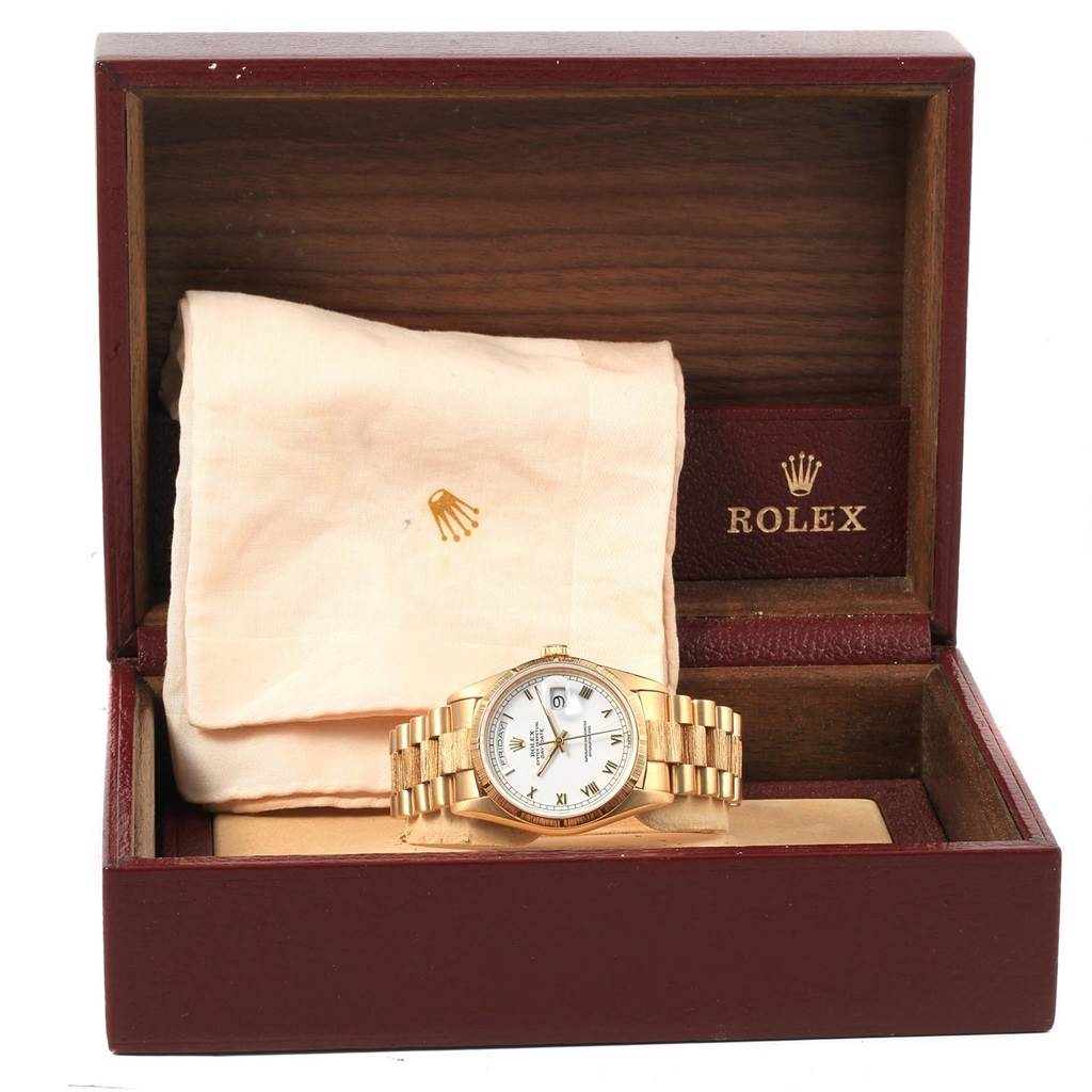 The image shows a Rolex President 18248 Men
s Yellow Gold White Dial 18248 Men
s Yellow Gold White Dial model watch displayed in its open box, revealing the dial, bracelet, and brand accessories.