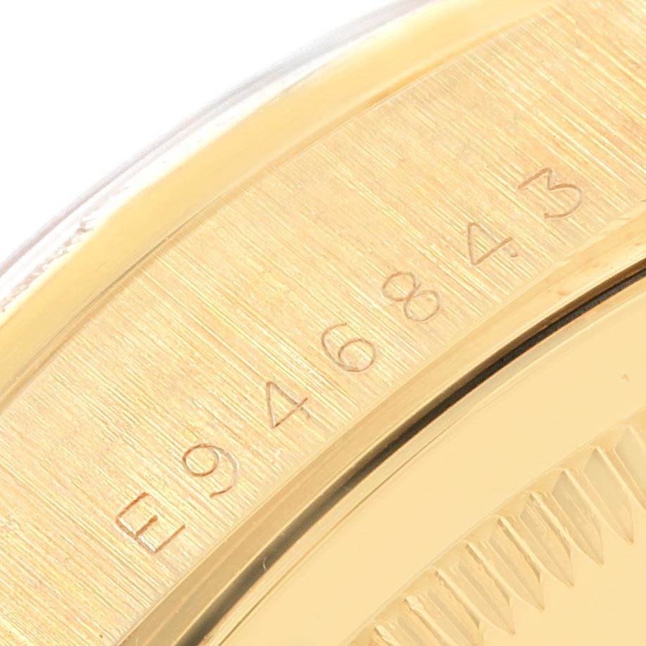 This close-up image shows the engraved serial numbers on the gold casing of a Rolex President 18248 Men
s Yellow Gold White Dial 18248 Men
s Yellow Gold White Dial model watch.