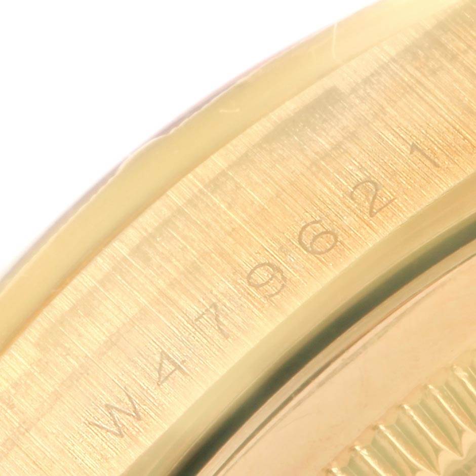 The image shows a close-up of the Rolex President 18248 Men's Yellow Gold Mother of Pearl Dial 18248 Men's Yellow Gold Mother of Pearl Dial model's case edge, featuring its serial number engraving.