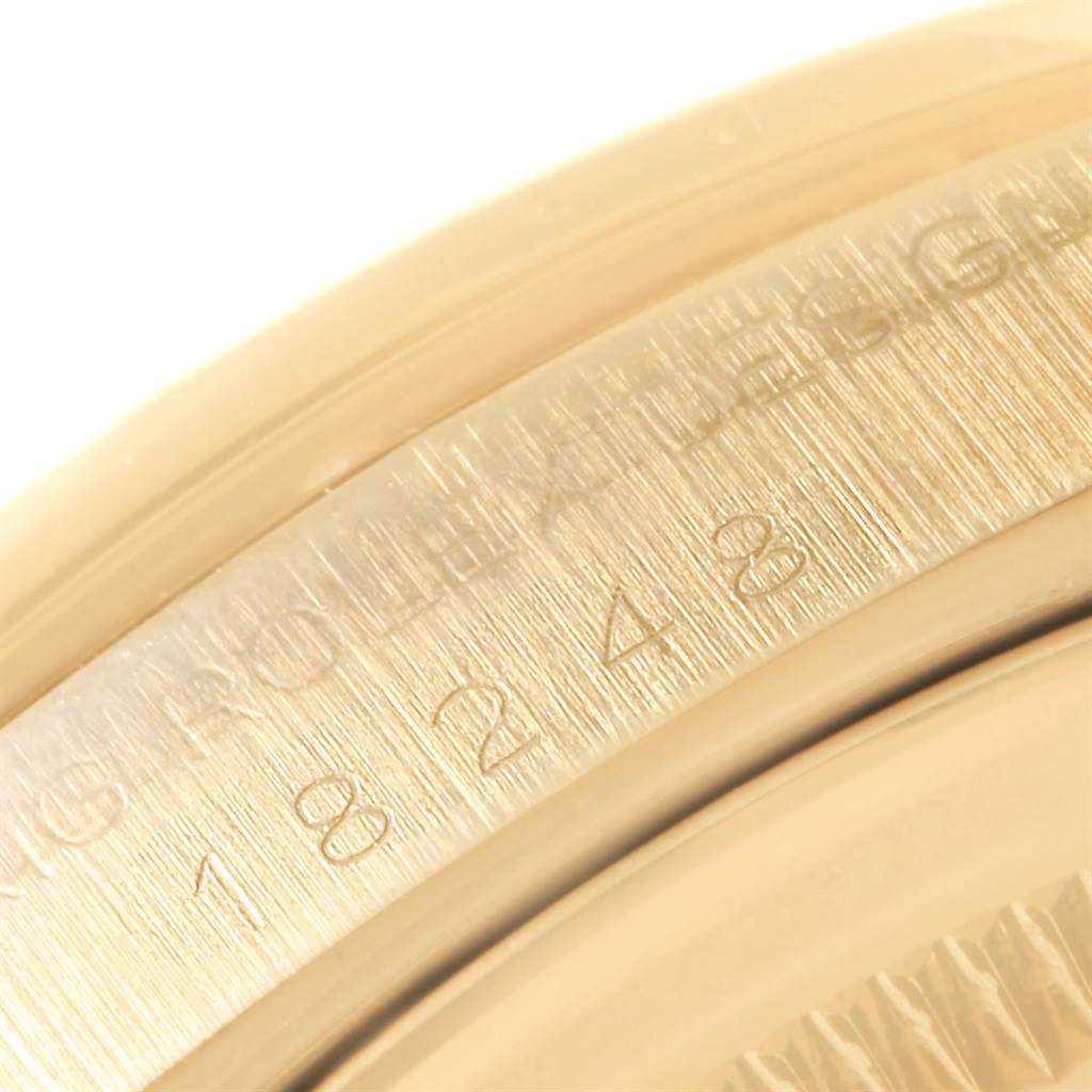 The image shows a close-up of the Rolex President 18248 Men's Yellow Gold Brown Dial 18248 Men's Yellow Gold Brown Dial model watch, focusing on the engraved serial number and part of the bezel.