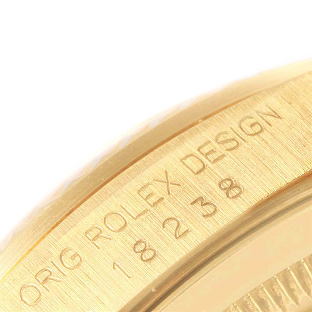 The image shows a close-up of the side of the bezel engraved with "ORIG ROLEX DESIGN" and the model number for the Rolex President 18238 Men
s Yellow Gold Champagne Dial 18238 Men
s Yellow Gold Champagne Dial watch.