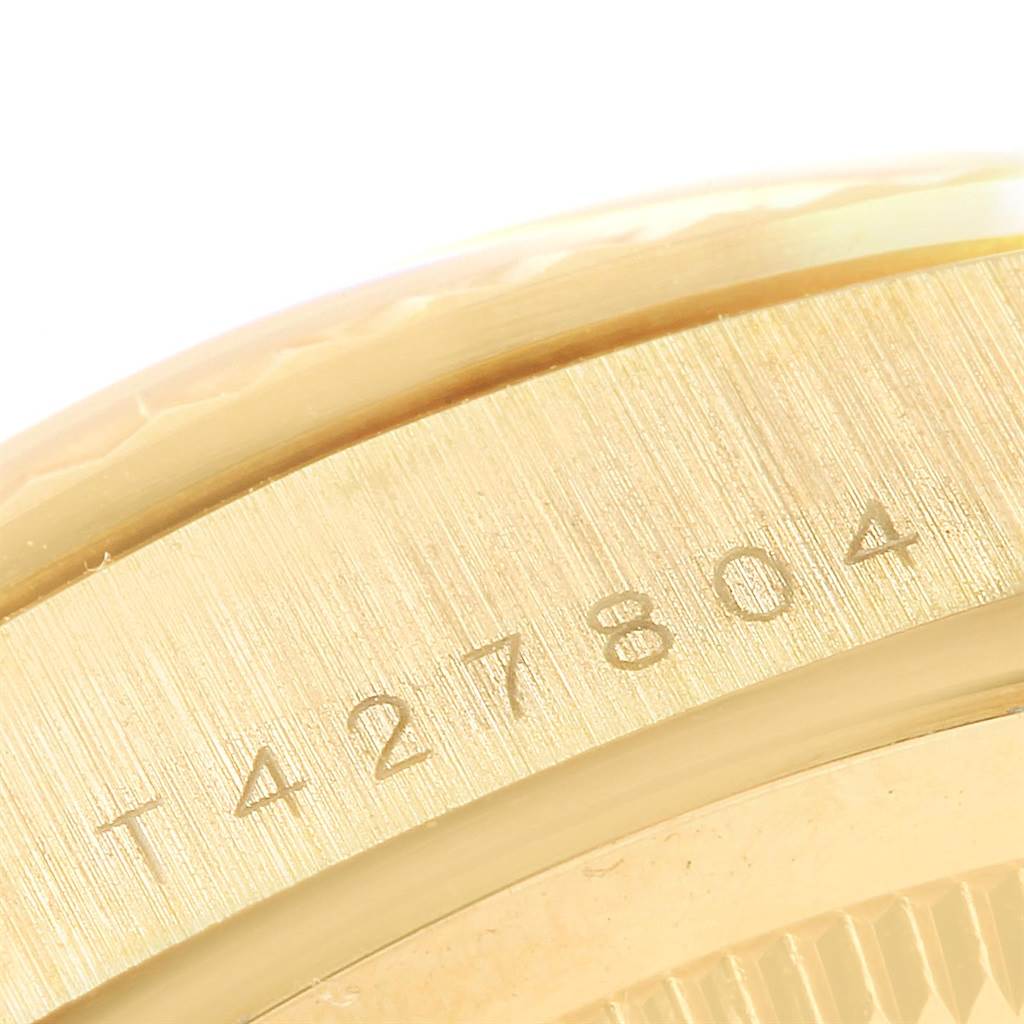 The image shows a close-up of the case side and engraved serial number on a Rolex President 18238 Men
s Yellow Gold Champagne Dial 18238 Men
s Yellow Gold Champagne Dial model watch.