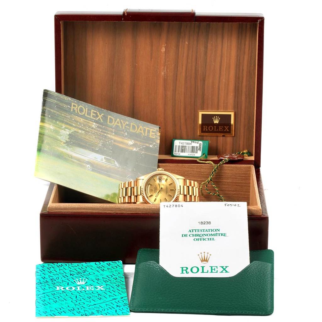 The Rolex President 18238 Men
s Yellow Gold Champagne Dial 18238 Men
s Yellow Gold Champagne Dial watch and its accessories are displayed in an open box, showing the watch, manuals, and Best Quality
ation papers.