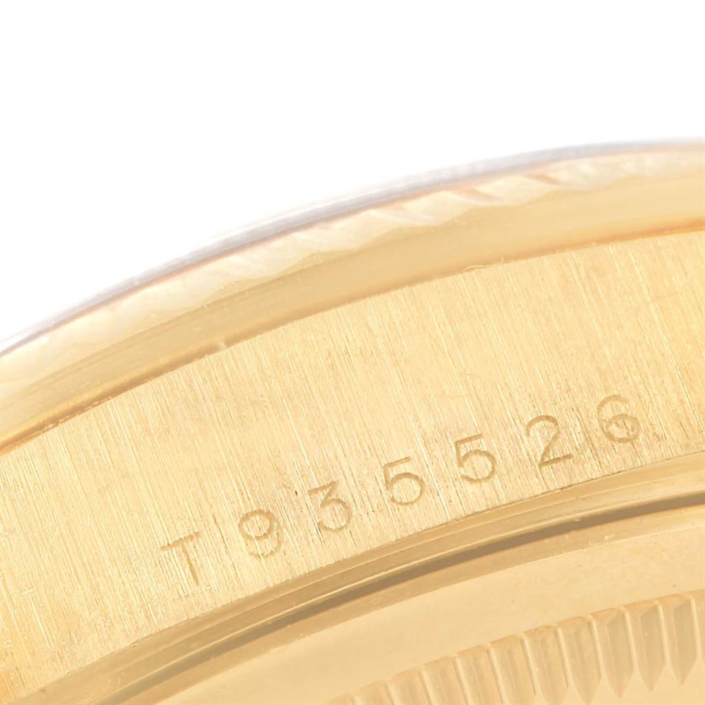 The image shows a close-up of the side of the Rolex President 18238 Men's Yellow Gold Champagne Dial 18238 Men's Yellow Gold Champagne Dial model, highlighting the serial number engraved on the case.
