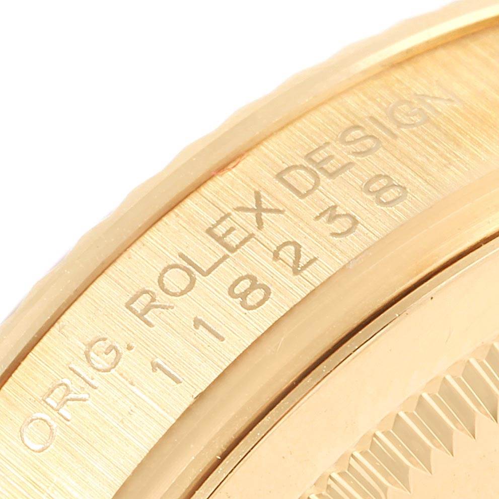 The image shows a close-up of the side of a Rolex President 118238 Men's Yellow Gold White Dial 118238 Men's Yellow Gold White Dial watch, highlighting the engraved model information.