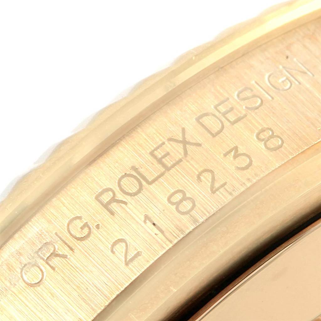 This close-up image focuses on the engraved serial number and model details on the bezel of a Rolex President 218238 Men's Yellow Gold Champagne Dial 218238 Men's Yellow Gold Champagne Dial watch.