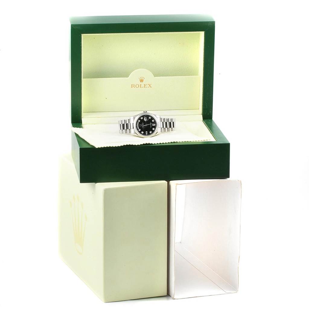 The Rolex President 118239 Men's White Gold Black Dial 118239 Men's White Gold Black Dial watch is shown from the front, placed inside its green and cream display box.