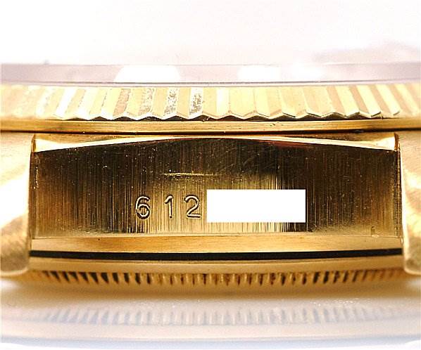 This image shows a close-up of the case and bezel of a Rolex President 18038 Men's Yellow Gold Silver Dial 18038 Men's Yellow Gold Silver Dial model watch with a visible serial number.