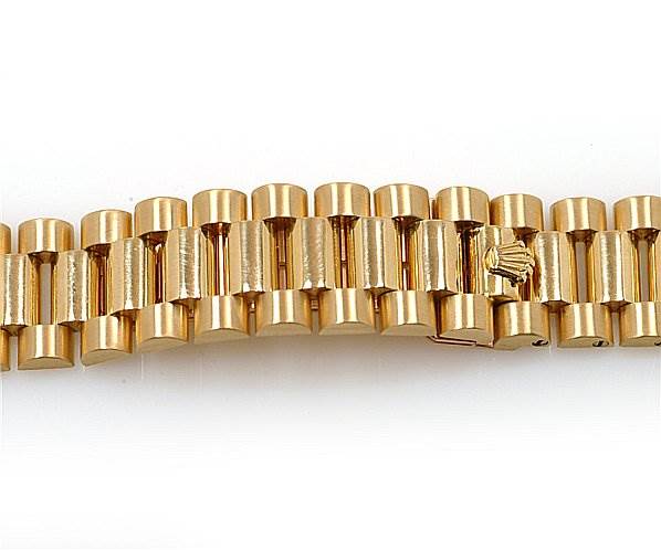This image shows a close-up of the gold bracelet links of a Rolex President 18038 Men's Yellow Gold Silver Dial 18038 Men's Yellow Gold Silver Dial model watch.