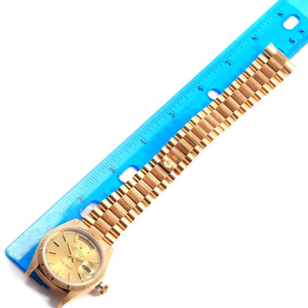 This image shows the face and bracelet of a Rolex President 18078 Men
s Yellow Gold Champagne Dial 18078 Men
s Yellow Gold Champagne Dial model watch, measured alongside a blue ruler.