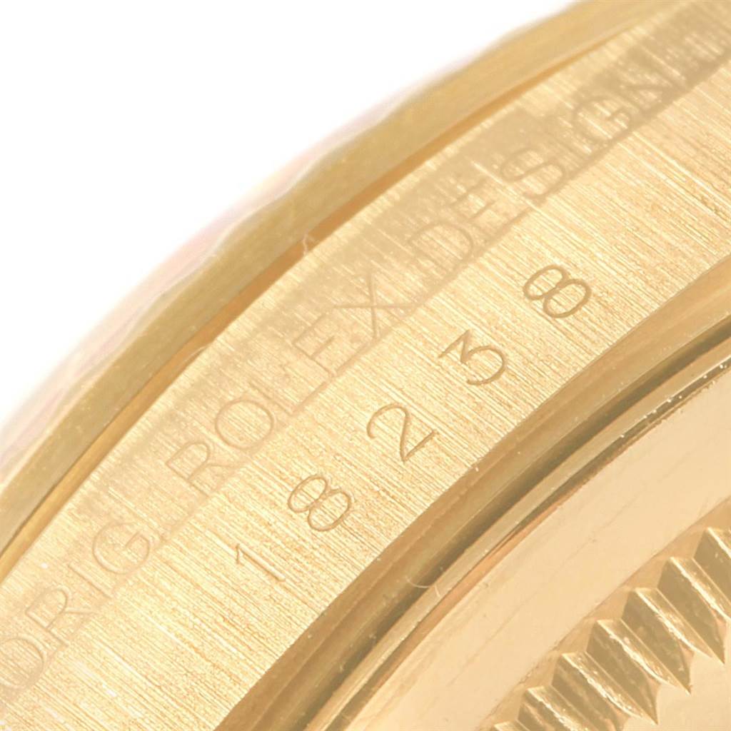 This close-up image shows the side of the case and bezel of a Rolex President 18238 Men's Yellow Gold Black Dial 18238 Men's Yellow Gold Black Dial model watch.