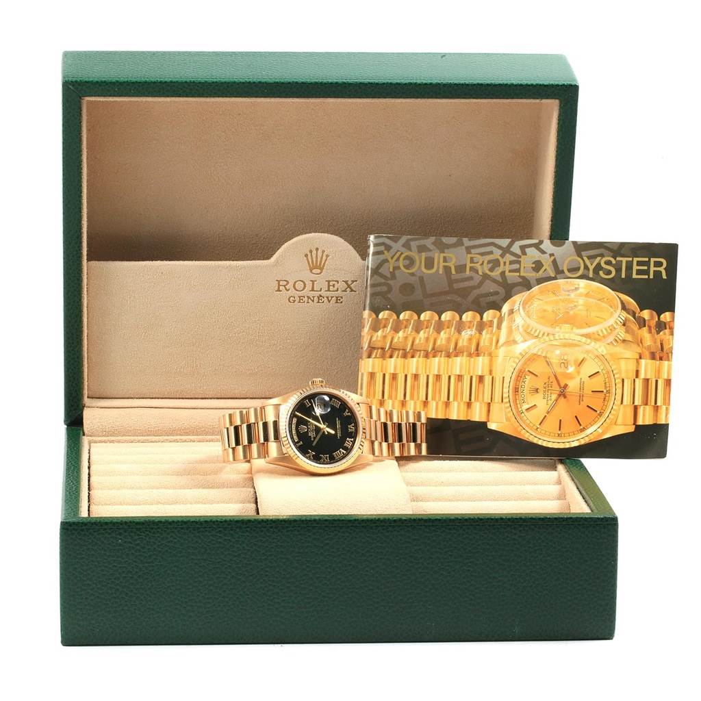 The image shows a Rolex President 18238 Men's Yellow Gold Black Dial 18238 Men's Yellow Gold Black Dial model watch displayed in its box with a brochure beside it.