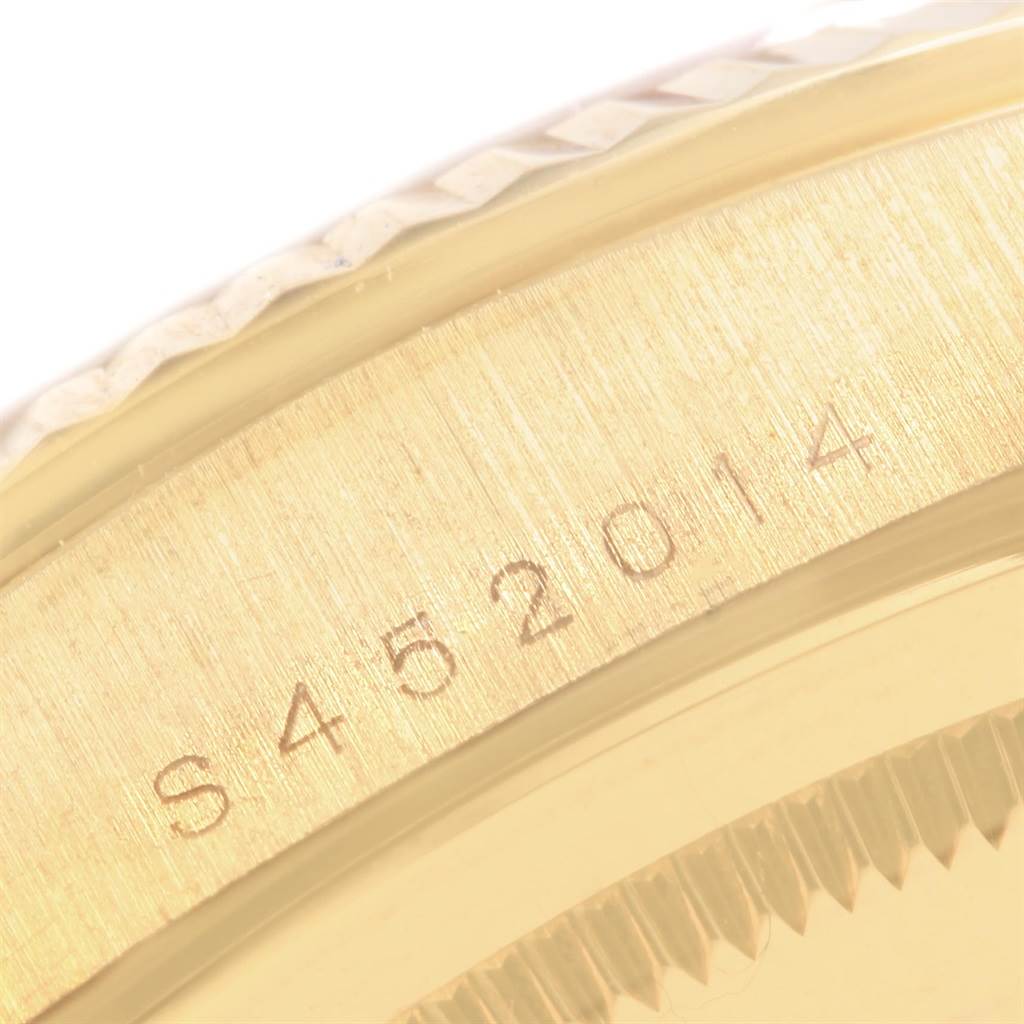 This image shows a close-up of the side of the Rolex President 18238 Men's Yellow Gold Black Dial 18238 Men's Yellow Gold Black Dial model, focusing on its serial number engraving.