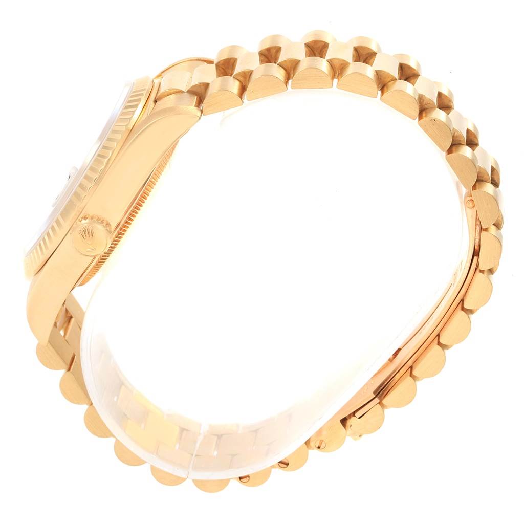 The image shows a side view of a Rolex President 18238 Men's Yellow Gold Black Dial 18238 Men's Yellow Gold Black Dial watch, focusing on its gold bracelet and crown.