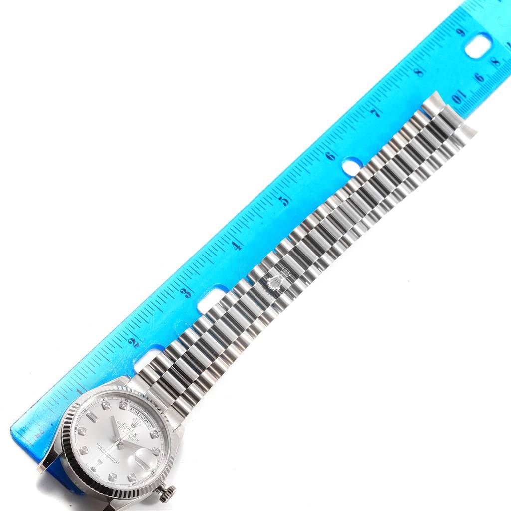 The image shows a top view of the Rolex President 118239 Men's White Gold Silver Dial 118239 Men's White Gold Silver Dial watch with its watch band extended beside a ruler.