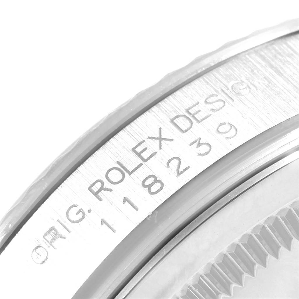 This image shows a close-up of the case side and engraved serial numbers on a Rolex President 118239 Men's White Gold Silver Dial 118239 Men's White Gold Silver Dial model watch.