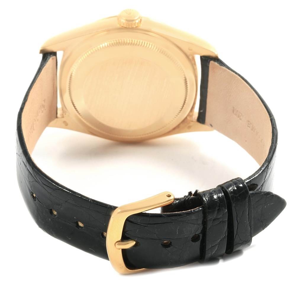 The image shows the back case and black leather strap of a Rolex President 18238 Men's Yellow Gold Champagne Dial 18238 Men's Yellow Gold Champagne Dial model watch.