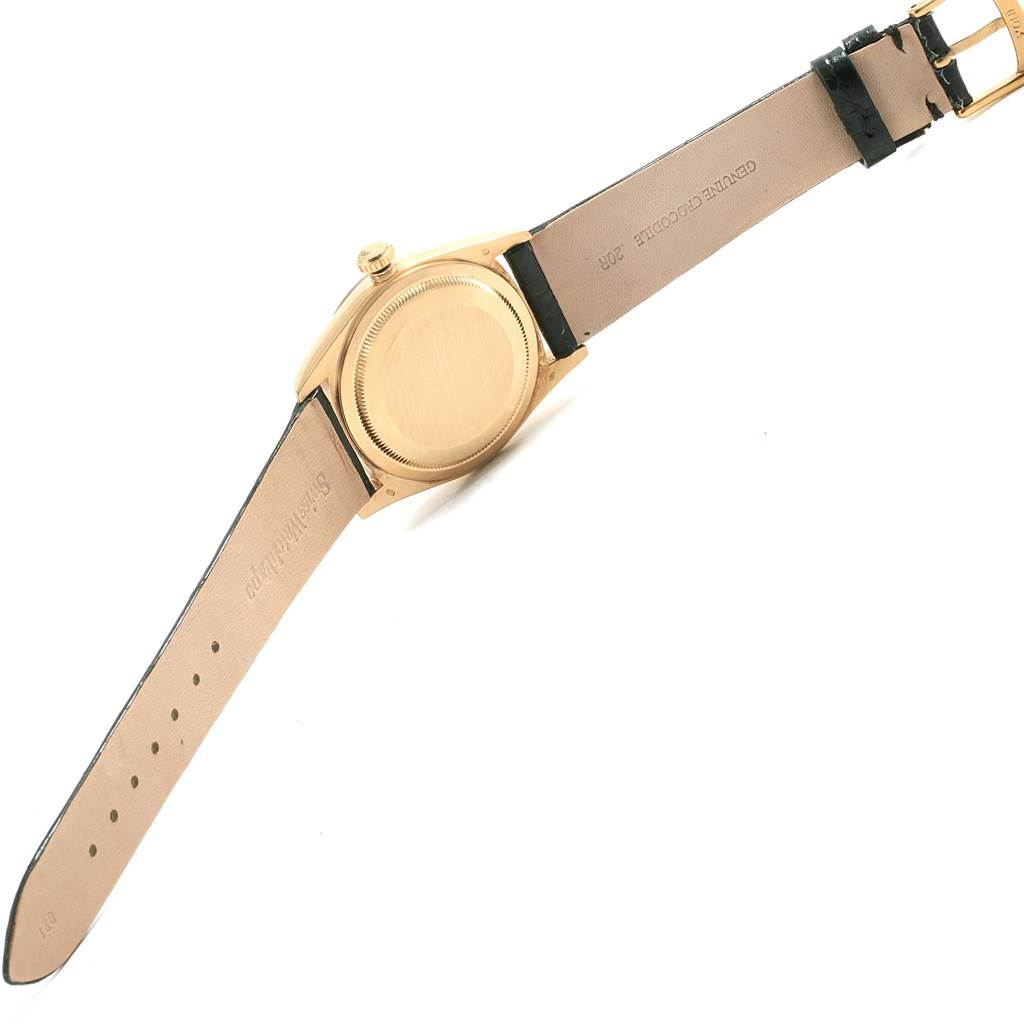 This image shows the back and strap of a Rolex President 18238 Men's Yellow Gold Champagne Dial 18238 Men's Yellow Gold Champagne Dial model watch from a top-down angle.